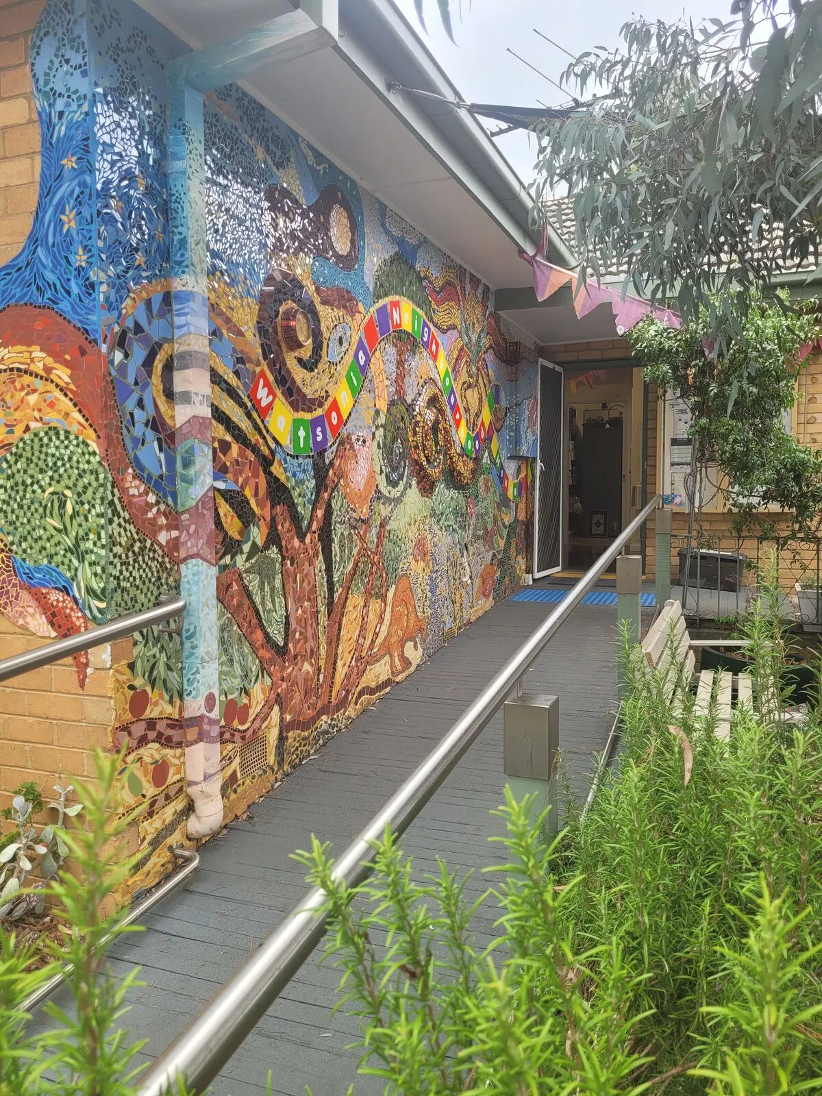 The entry to Watsonia Neighbourhood House, a path leading to the front door past the garden