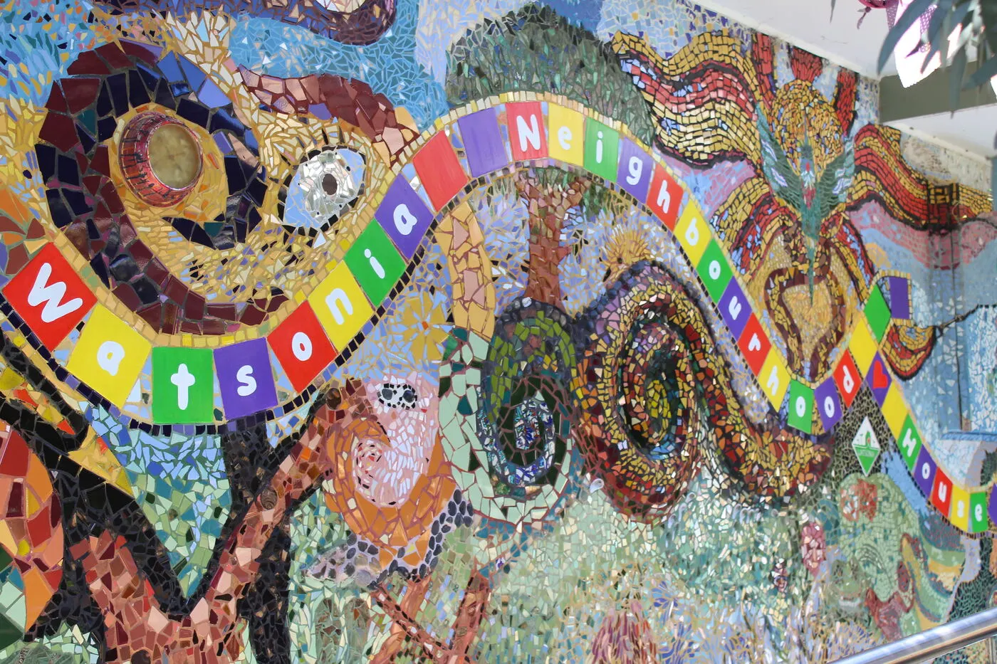 A detail of the community mosaic, spelling out Watsonia Neighbourhood House in coloured tiles
